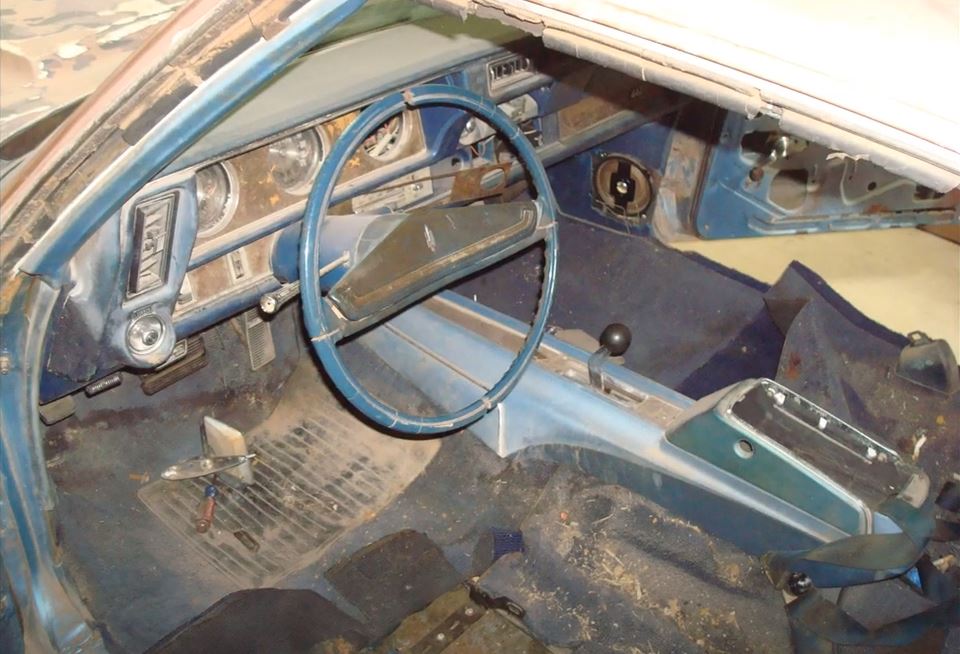 The interior of the car was in equally poor shape, with torn and frayed upholstery, cracked dashboard components, and broken or missing trim pieces. The carpets were stained and worn, and the headliner sagged from age and moisture damage.