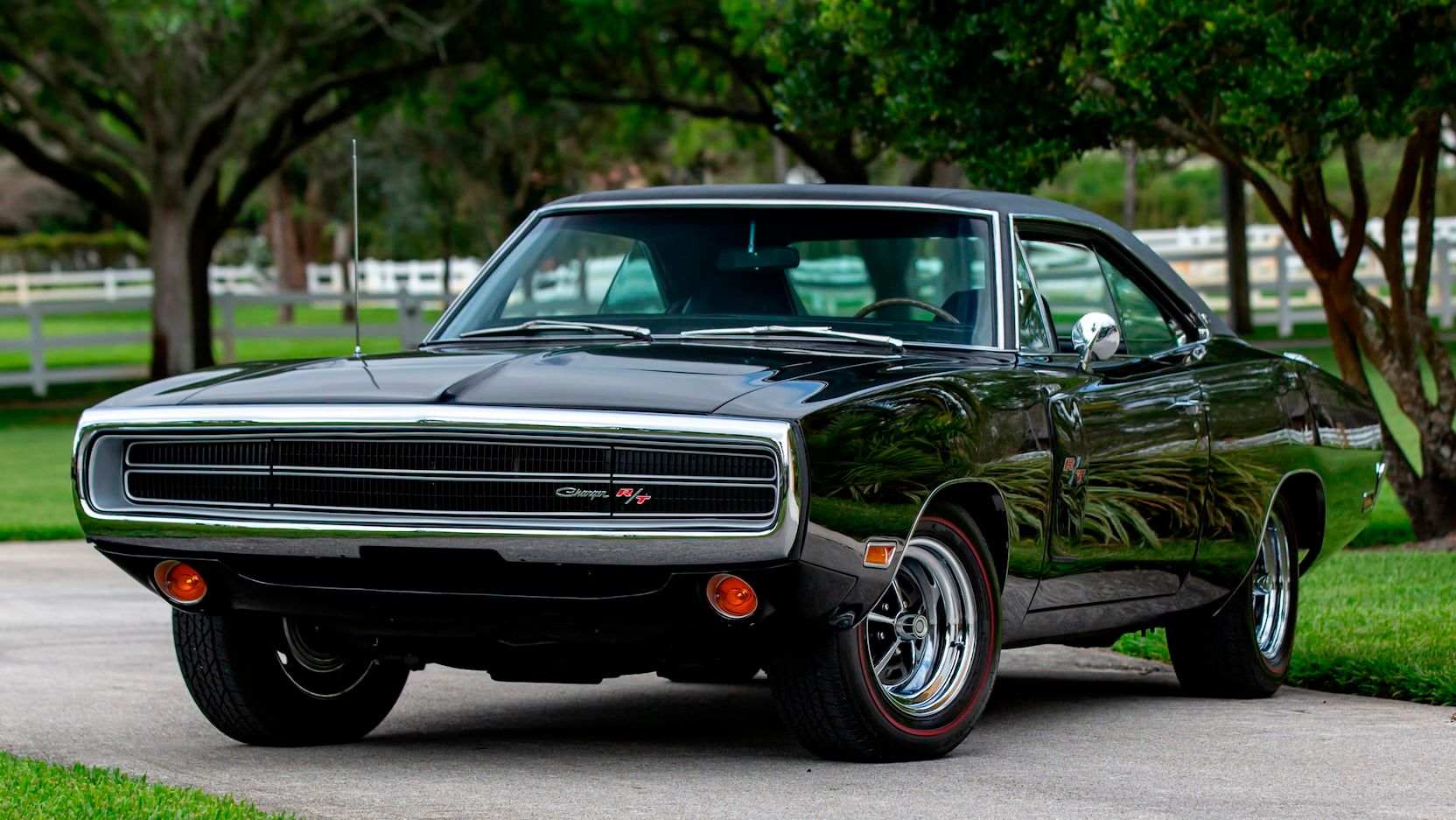 A parked black 1970 Dodge Charger R/T SE