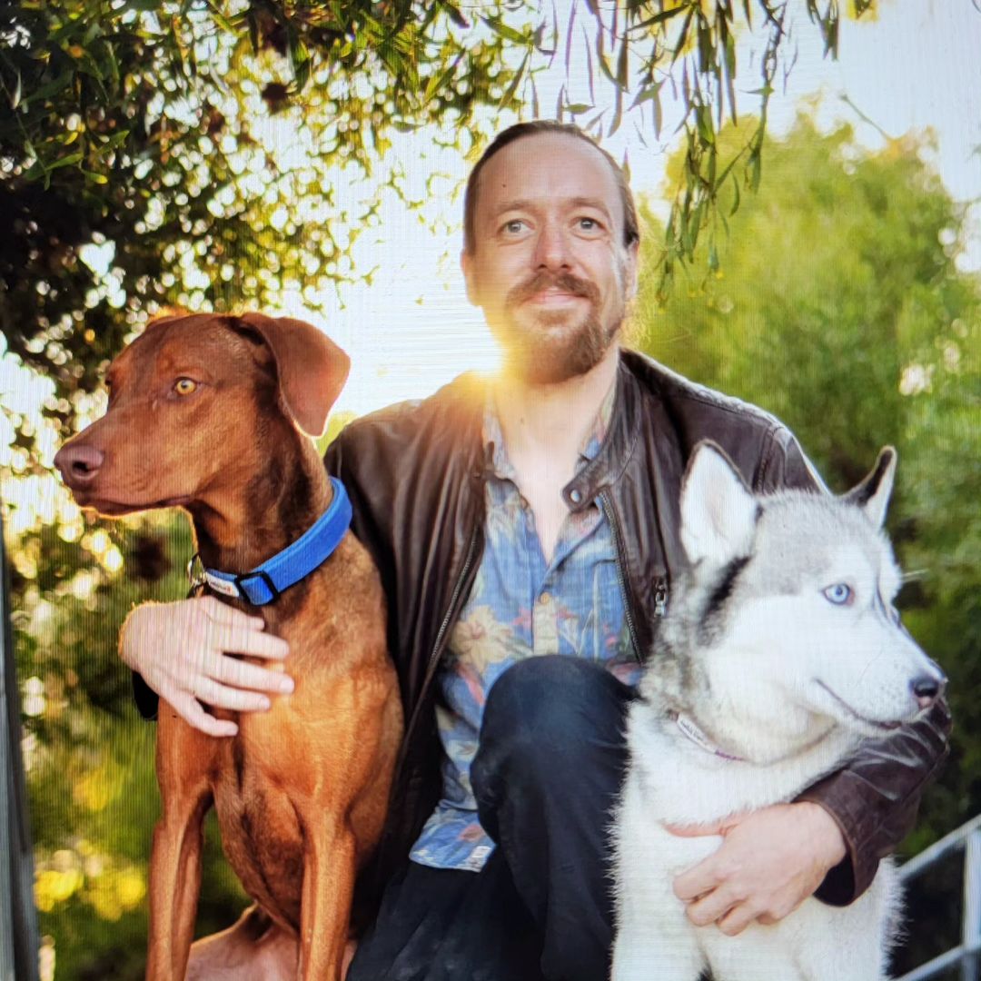 Man holding two dogs